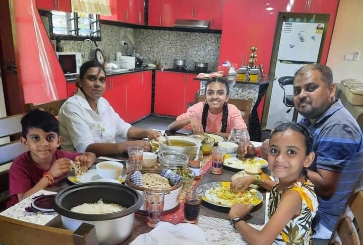 Krishiya Kumar (right) sharing a meal with her family