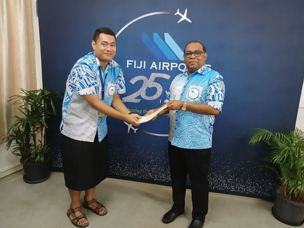Toga Nasile receives his ICAO 052 Certificate from Fiji Airports CEO, Mesake Nawari at the graduation ceremony in Nadi.