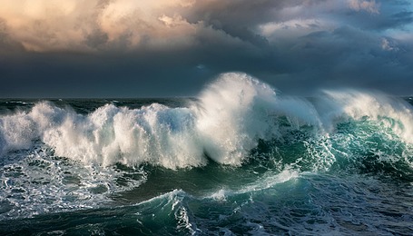 Powerful waves crash in a stormy sea.